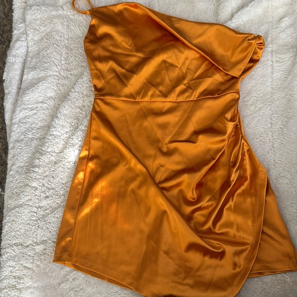 Orange dress with shorts underneath, one strap